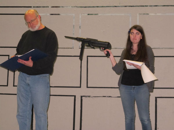 Newspaper editor Horace (Patrick Kennerly) finds himself at gunpoint from Meredith (Emma Sala.)