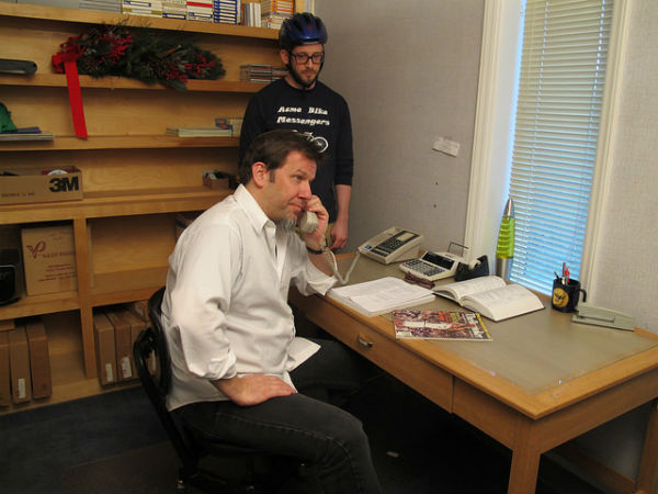Chris Shepard (foreground) as manager of Acme Bike Messengers and Blair Peyton as his incompetent employee.