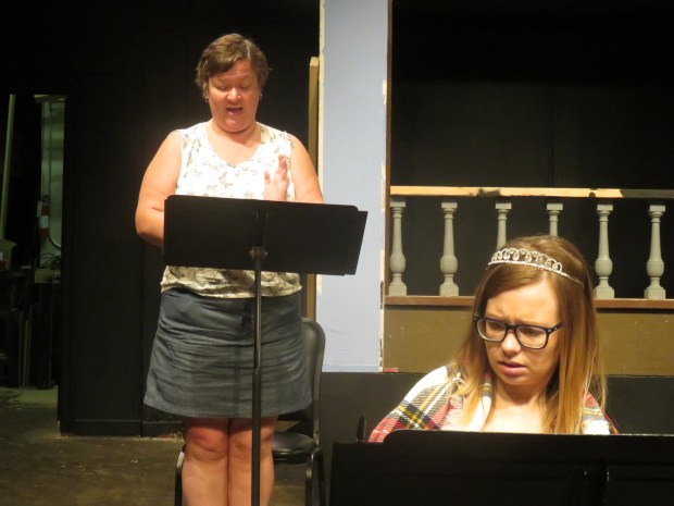 Miss Battleaxe hovers over everything.